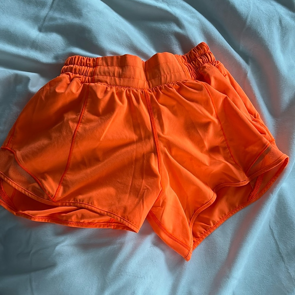 Bright orange lululemon low rise size 2 shorts. These are also 4 in.